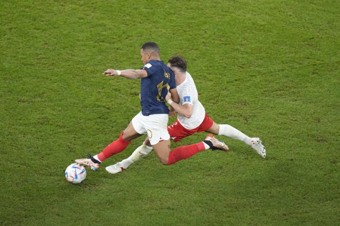 Kylian Mbappé (left) in a duel with Matthew Cash during the France-Poland World Cup match, Sunday, December 4, 2022, at the Al-Thumama Stadium, in Doha. 