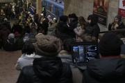 People rest in the subway station being used as a bomb shelter during a rocket attack in Kyiv, on Monday, December 5, 2022. 