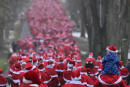 People dressed in Santa Claus costumes take part in the annual christmas run in Michendorf, on December 4, 2022. (Photo by John MACDOUGALL / AFP)