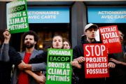 Environmental activists demonstrate against TotalEnergies in Paris on May 25, 2022.
