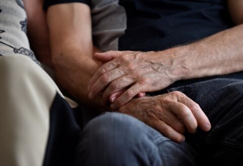 Sylvie Richard, 67, who suffers from an incurable form of cancer holds hands with her partner Bernard Lacour, 66, during an interview on June 1, 2018 in Pont-a-Mousson, eastern France. - Sylvie Richard, who suffers from peritoneal carcinomatosis, a cancer which was diagnosed in April 2017, learned in January 2018 that her request for euthanasia had been accepted in Belgium. (Photo by JEAN-CHRISTOPHE VERHAEGEN / AFP)