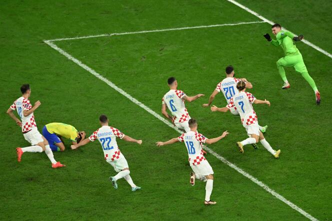 Les Croates célèbrent leur qualification pour les demi-finales de la Coupe du monde 2022, vendredi 9 décembre 2022, à Al-Rayyan (Qatar), après le tir au but manqué du Brésilien Marquinhos, agenouillé. 