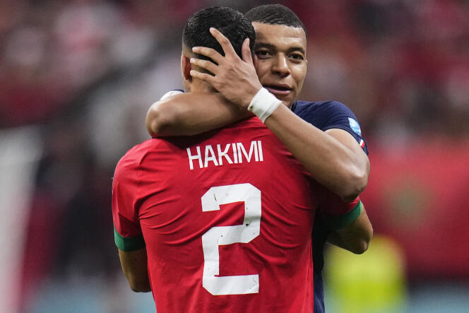 French forward Kylian Mbappe shares a kiss with Morocco's Ashraf Hakim during the semi-final match on the lawn of Al-Beit Stadium on December 14, 2022 in Al Khor, Qatar.