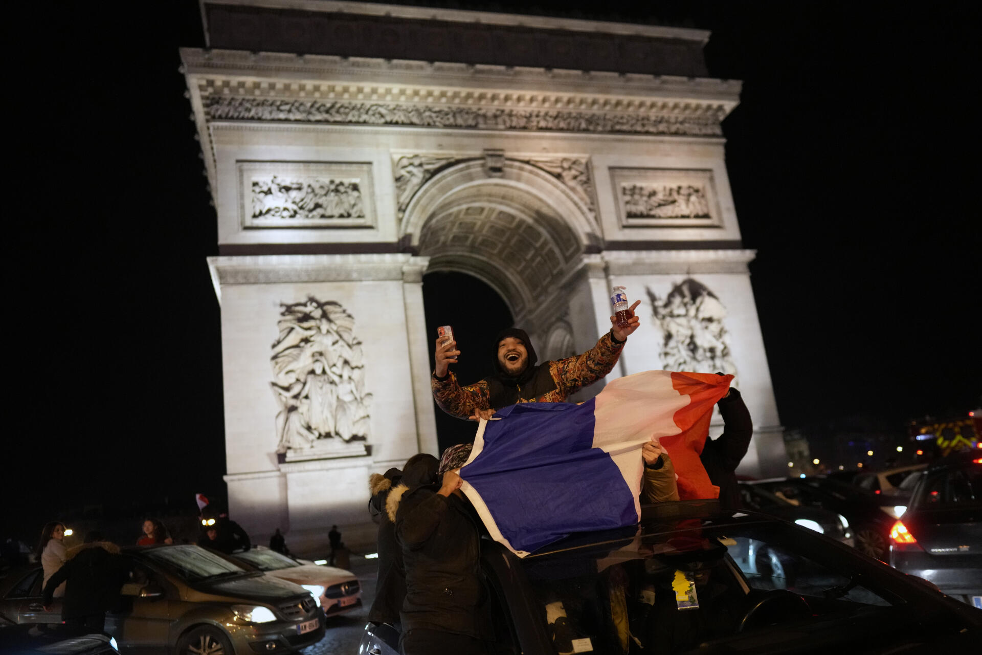 Des supporteurs célèbrent la victoire de la France sur les Champs-Elysées, à Paris, le 14 décembre 2022.