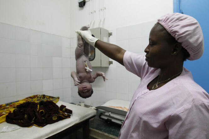 A midwife cares for a newborn at Man General Hospital in Côte d'Ivoire in 2013.