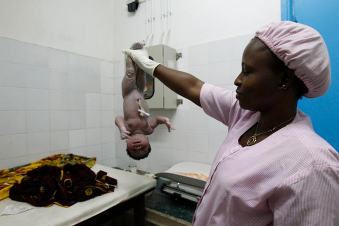 A midwife cares for a newborn at Man General Hospital in Côte d'Ivoire in 2013.