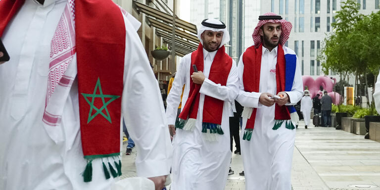 Morocco's team supporters walk in a street before the World Cup quarterfinal soccer match between Morocco and Portugal, in Doha, Qatar, Saturday, Dec. 10, 2022. (AP Photo/Pavel Golovkin)