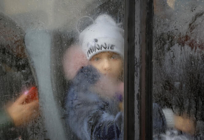 A boy evacuated from the city of Kherson, then under Russian control, on a bus bound for Crimea, in the city of Olechky (Ukraine), October 23, 2022.