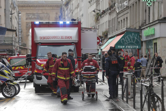 Fire brigade medics work on the scene where a shooting took place in Paris, Friday, December 23, 2022.