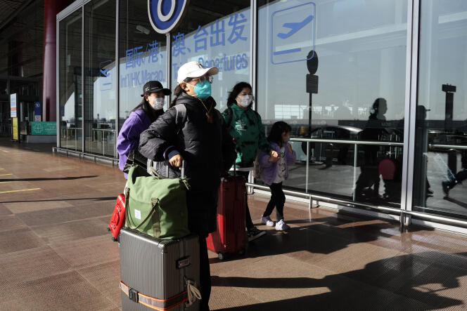 Passengers arrive at Beijing Airport on December 13, 2022.