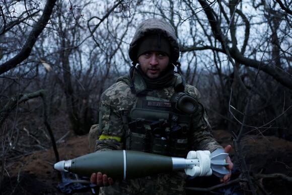 A Ukrainian soldier prepares to fire a mortar shell in Donetsk Oblast on December 31, 2022.