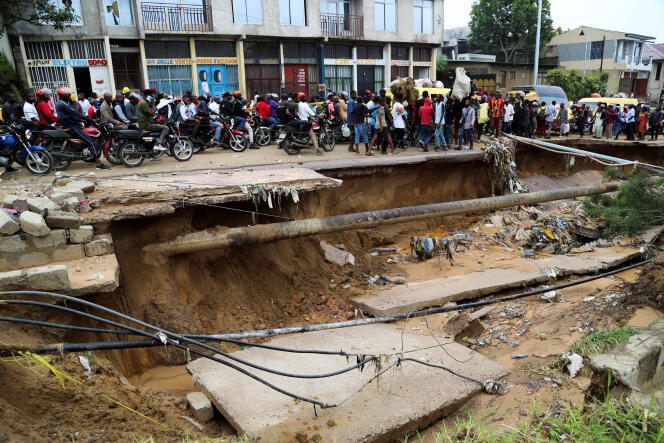 A road severely damaged after heavy rains caused flooding and landslides in the suburbs of Kinshasa, December 14, 2022. 