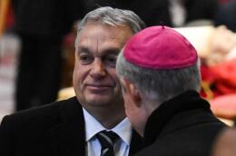 Archbishop Georg Ganswein welcomes Hungarian Prime Minister Viktor Orban (L) as he arrives to pay their respects to Pope Emeritus Benedict XVI as his body lays in state at St. Peter's Basilica in the Vatican, on January 3, 2023. Benedict, a conservative intellectual who in 2013 became the first pontiff in six centuries to resign, died on December 31, 2022, at the age of 95. Thousands of Catholics began paying their respects on January 2, 2023 to former pope Benedict XVI at St Peter's Basilica at the Vatican, at the start of three days of lying-in-state before his funeral. (Photo by Tiziana FABI / AFP)