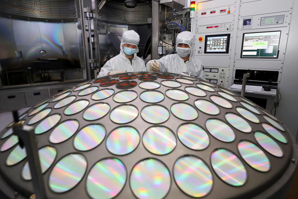 Employees work on the semiconductor chip production line of Jiangsu Azure Corp in Huaian, Jiangsu province, China March 25, 2022. China Daily via REUTERS ATTENTION EDITORS - THIS IMAGE WAS PROVIDED BY A THIRD PARTY. CHINA OUT.