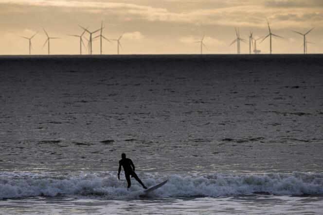 Le premier parc éolien en mer de France, vu depuis la Baule par un surfeur, en janvier 2022. 