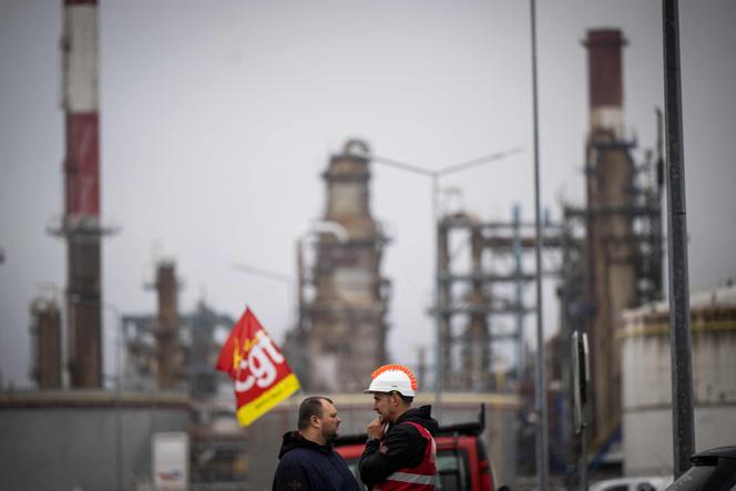 In this file photo taken on October 14, 2022 Trade unionists and striking employees gather outside the TotalEnergies refinery site, in Donges, western France. 