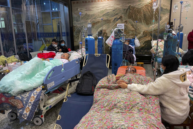 People take care of their relatives in the auditorium of Changhai Hospital in Shanghai, China, January 3, 2023.