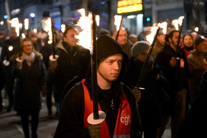 Protesters take part in a torch-lit march called by the CGT workers' union to protest the French government's pensions reform plan, on the Canebière in Marseille, France, on January 17, 2023.