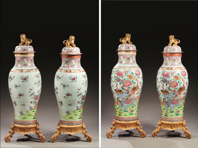 Pareja de grandes jarrones palaciegos en porcelana con decoración policromada y dorada con esmaltes famille rose de una pareja de fénix en un parque con barrera florida y rocas horadadas.  Período Qianlong (1735-1796).  Zócalos de madera tallada y dorada.