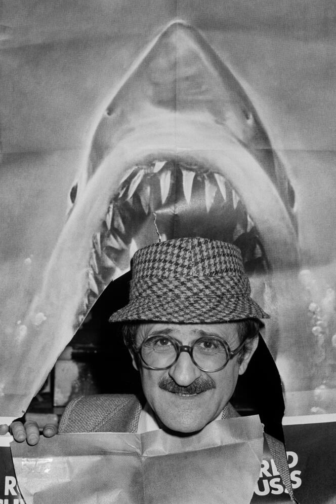 Marcel Zanini pose devant l’affiche du film « Les Dents de la mer », à Paris, le 27 février 1976.