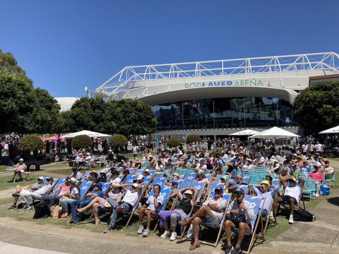 Spectators watch the Australian Open on a giant screen at 'Garden Square' on Friday, January 20, 2023 at Melbourne Park, where the Australian tournament is held.