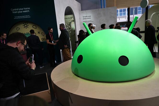 Visitors take photos of a mock-up of Android, Google's logo, during the Consumer Electronics Show (CES) in Las Vegas, Nevada, Jan. 5, 2023. 