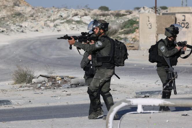 Israeli troops aim their weapons during confrontations with Palestinian demonstrators in the West Bank town of Al-Ram on January 27, 2023, a day after a deadly Israeli raid on the Jenin camp. 