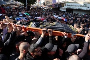 Palestinians carry the bodies of victims of an Israeli raid on the Jenin refugee camp in the West Bank on January 26.