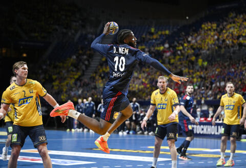 France's Dika Mem in action during the IHF Men's World Championship handball semi final between France and Sweden at Tele2 Arena, in Stockholm, Sweden, Friday Jan. 27, 2023. (Anders Wiklund/TT News Agency via AP)