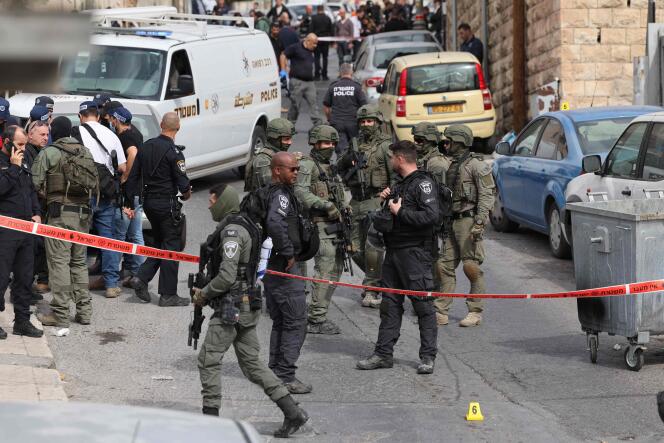 Israeli security forces and emergency service personnel gather at a cordoned-off area in Jerusalem's predominantly Arab neighborhood of Silwan, where an assailant reportedly shot and wounded two people, on January 28, 2023.