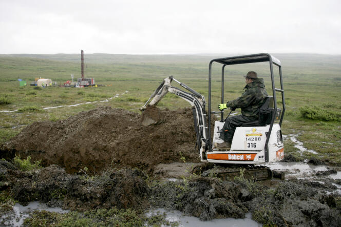 A worker with the Pebble Mine project digs in the Bristol Bay region of Alaska near the village of Iliamma, in 2007.