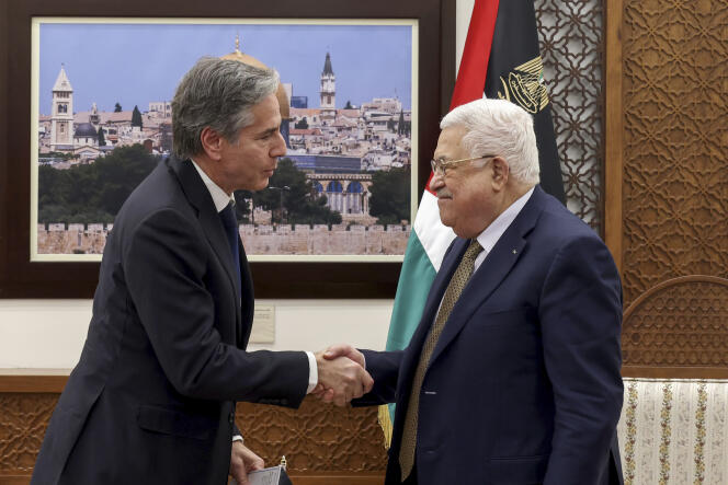 US Secretary of State Antony Blinken, left, and Palestinian leader Mahmoud Abbas shake hands following their meeting in the West Bank town of Ramallah, January 31, 2023. 