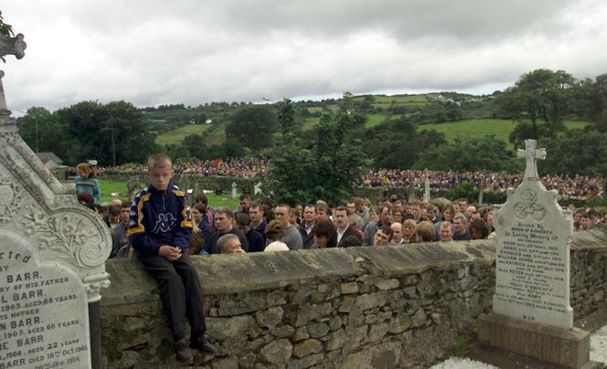 A crowd attends the funeral of the three boys killed in the Omagh bomb blast, at St Mary's Church in Buncrana, Northern Ireland, August 19, 1998.