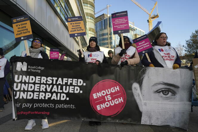Workers stand on the picket line outside Queen Elizabeth hospital during a strike by nurses and ambulance staff, in Birmingham, England.