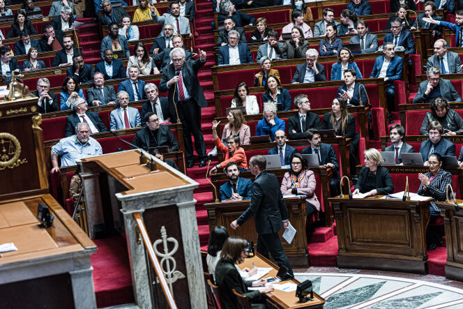 The Minister of Labour, Full Employment and Integration, Olivier Dussopt, joins the podium while Deputy André Chassaigne (PCF) speaks, at the National Assembly, in Paris, on February 6, 2023.