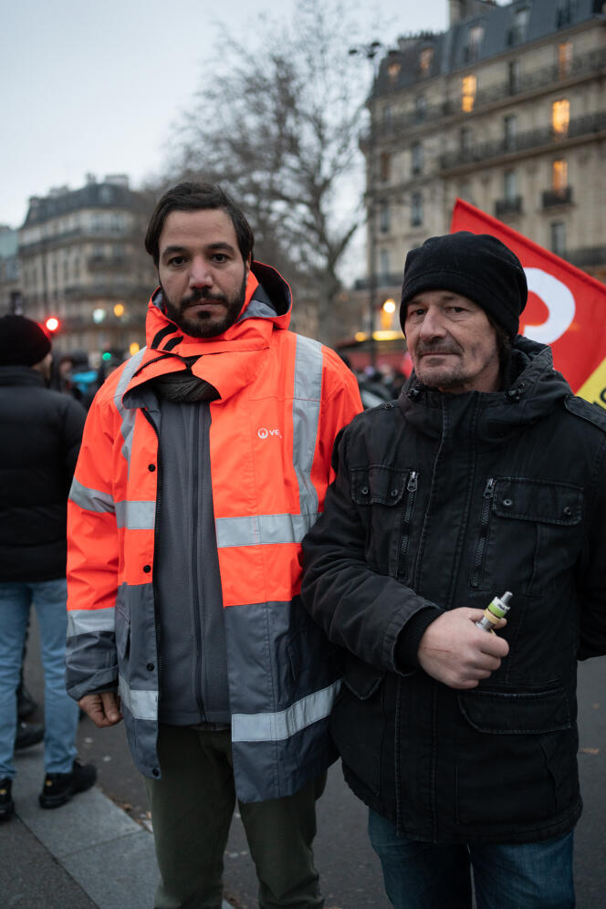 Yannick Sevenou (right), a plumber and CGT union delegate at Setha (Veolia), and Ali Chaligui (left), an employee at Taïs, Veolia's waste management subsidiary, during a demonstration against the pension reform in Paris on January 19, 2023.