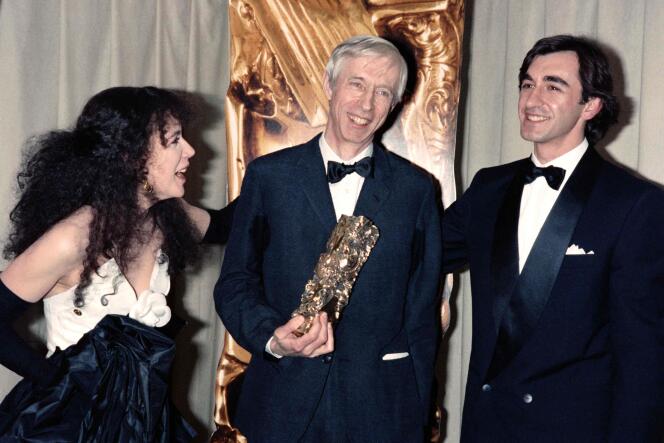 Michel Deville (center), winner of the César Award for Best Director for 'Death in a French Garden' at the 11th César Awards ceremony in 1986