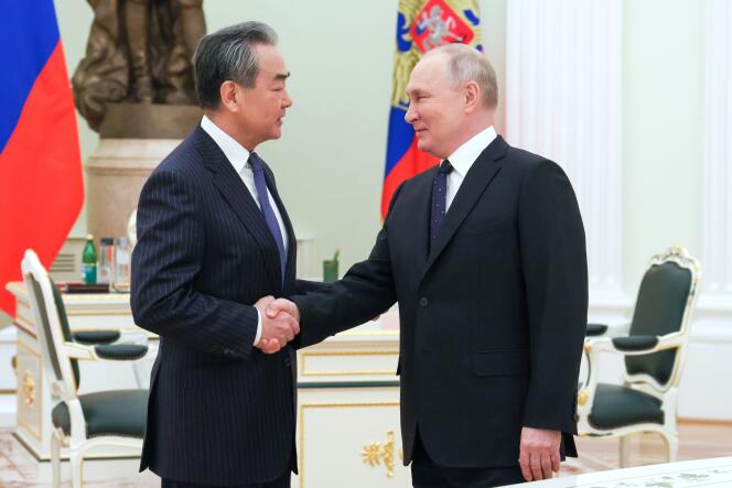 Director of the Office of the Foreign Affairs Commission of the Communist Party of China Central Committee Wang Yi and Russian President Vladimir Putin in the Kremlin on February 22, 2023. 