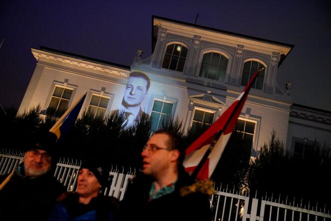 An image of Ukrainian President Volodymyr Zelenskiy is projected onto the Russian embassy building during a 