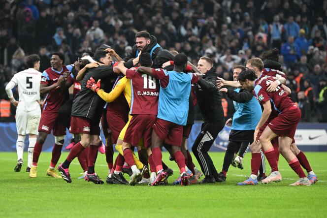 Annecy players celebrate their victory over Marseille at the Stade-Vélodrome on March 1, 2023, in the quarter-finals of the Coupe de France. 