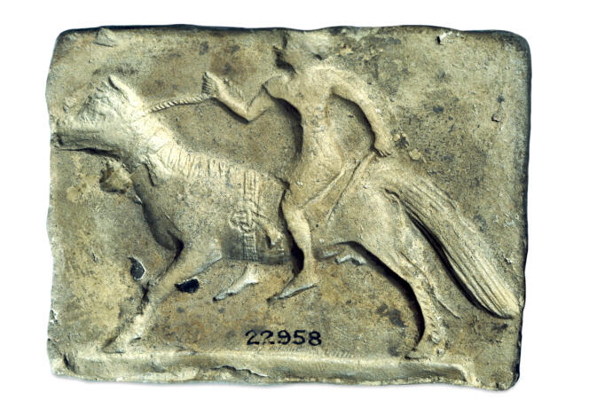 Mold of a baked clay plate representing a horseman, period of ancient Babylon.