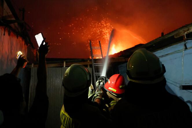 Firefighters try to extinguish a fire at a fuel storage station operated by Indonesia's state energy company Pertamina, in Jakarta, Indonesia, March 3, 2023. 