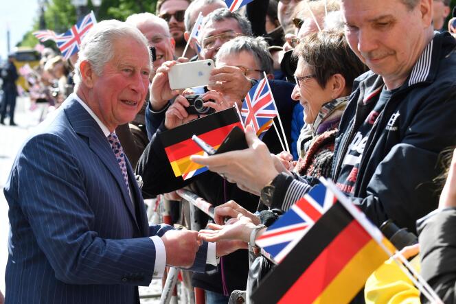 In this file photo taken on May 07, 2019 then Britain's Prince Charles, Prince of Wales greets the crowd during a visit at the Brandenburg Gate in Berlin. 