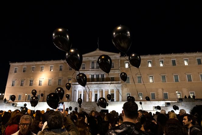 I manifestanti tengono palloncini neri durante una manifestazione silenziosa fuori dal Parlamento, ad Atene, in Grecia, il 3 marzo 2023.