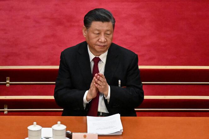 China's President Xi Jinping applauds during the opening session of the National People's Congress (NPC) at the Great Hall of the People in Beijing on March 5, 2023.
