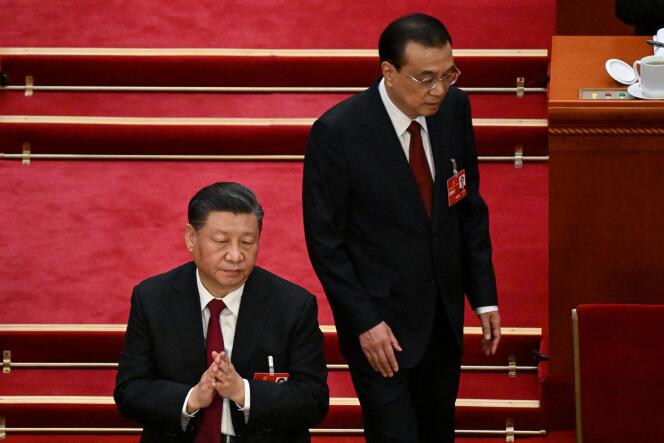 China's Premier Li Keqiang (R) walks past China's President Xi Jinping (C) after delivering his work report during the opening session of the National People's Congress (NPC) at the Great Hall of the People in Beijing on March 5, 2023.