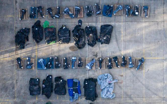 Rolled- up inflatable dinghies and outboard engines, stored in a Port Authority yard in Dover, southeast England on March 6, 2023, that are believed to have been used by migrants picked up at sea whilst crossing the English Channel. 