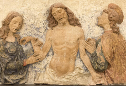 France. Paris 1st district. Musée du Louvre. Department of sculptures. Bas-relief " The dead Christ adored by saint Jean Evangelist and Marie-Madeleine " attributed to Domenico of Paris. Ferrara. Italy. The end of 15th century. Polychromatic terra-cotta