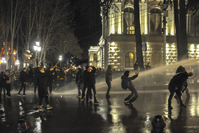 The police fire water cannon at protesters outside the Georgian parliament building in Tbilisi, Georgia, Tuesday, March 7, 2023. 