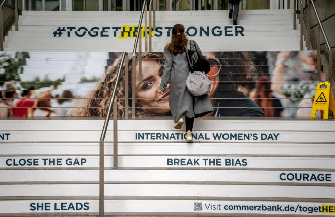 A woman walks up the decorated stairs of the Commerzbank in Frankfurt, Germany, Tuesday, March 7, 2023 on the eve of International Women's Day. 